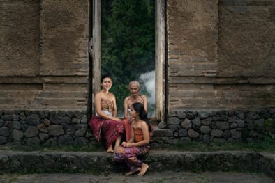 Three Balinese Women in traditional customs sitting in front of a door - Hotel Sidemen - Villa Uma Dewi Sri